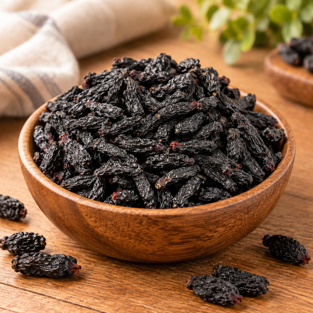 Create a photorealistic, high-end commercial lifestyle photograph for Large Black Raisins, using the uploaded image as t